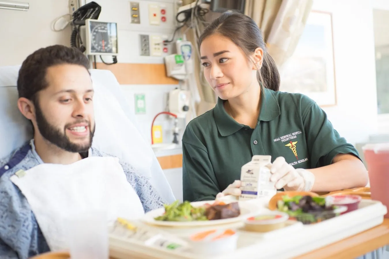 Health Scholar supporting a patient during a clinical care experience