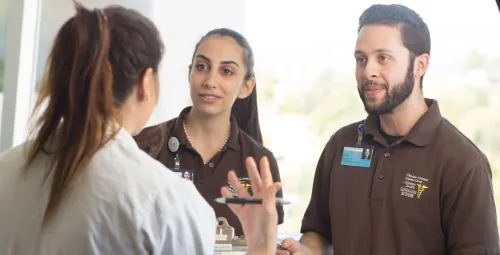 Health Scholars learning from a healthcare professional