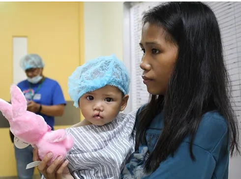 A caregiver holding a child during a healthcare service experience